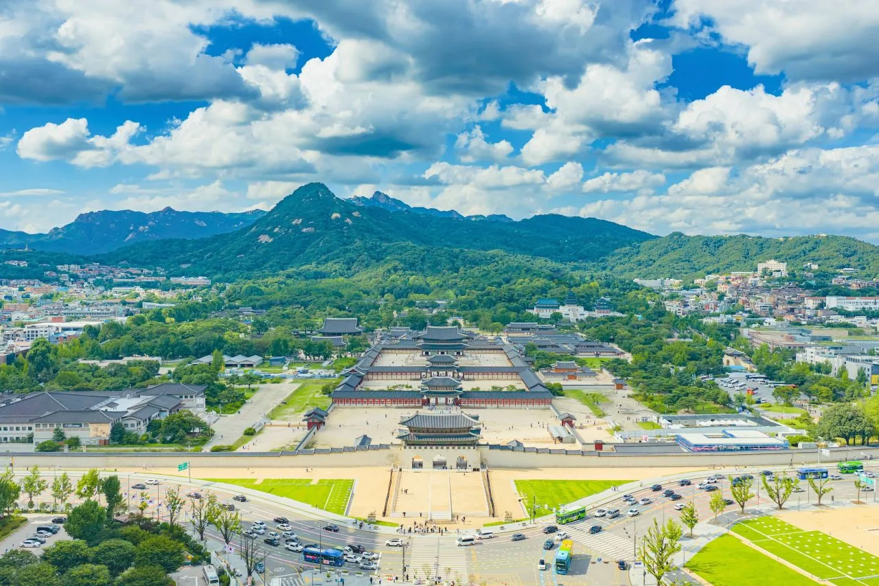 Snow settling on the tiled roofs and courtyard of Gyeongbokgung Palace in Seoul