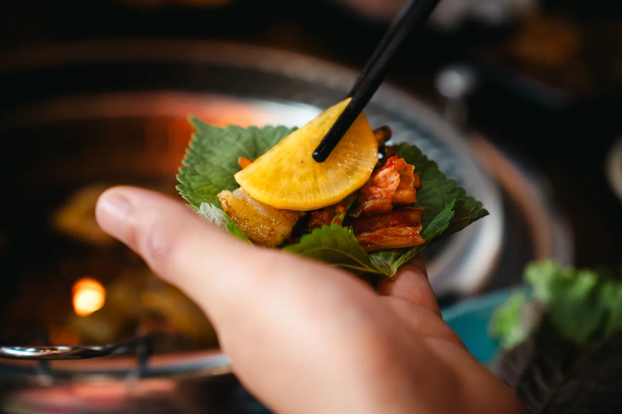 Samgyeopsal grilling on a tabletop grill