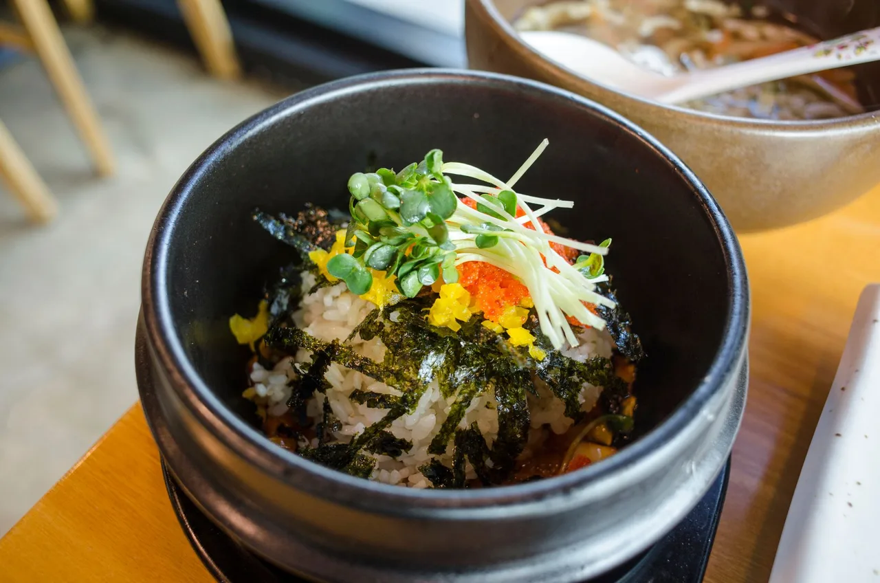 A steaming bowl of gukbap with rice