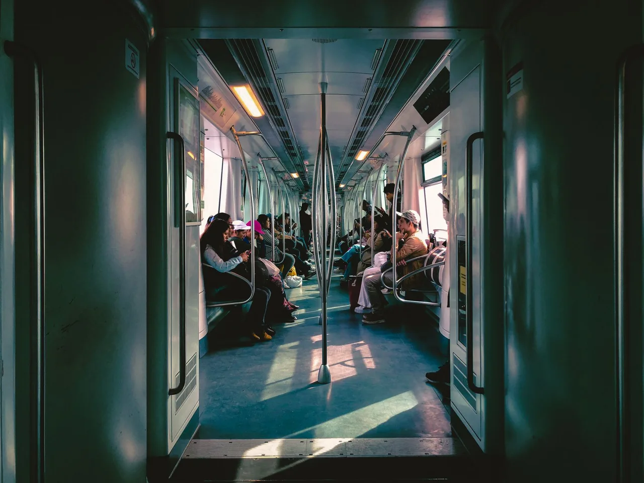 Commuters reading on their phones on the Seoul subway