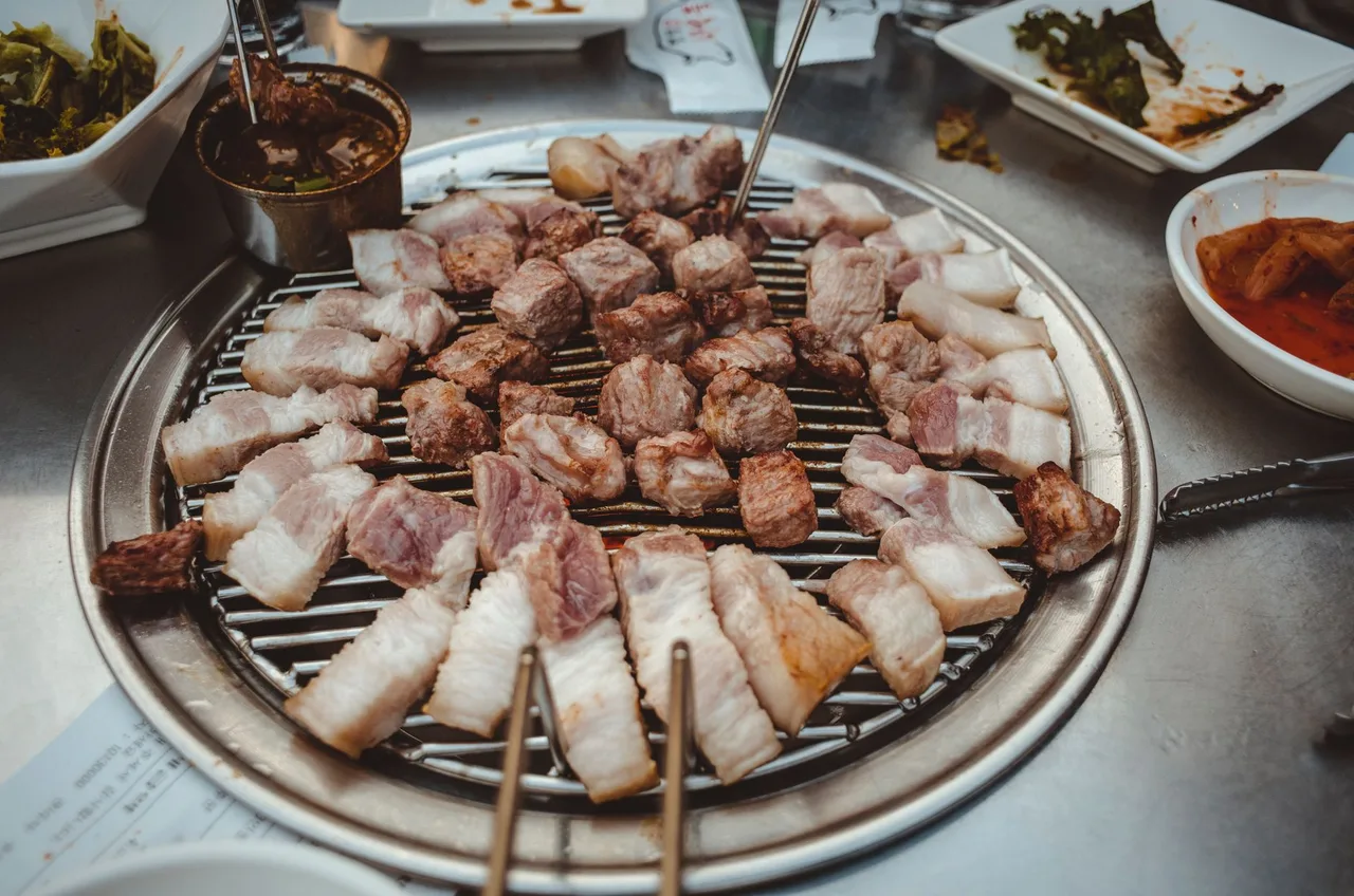 Sizzling samgyeopsal on a tabletop grill