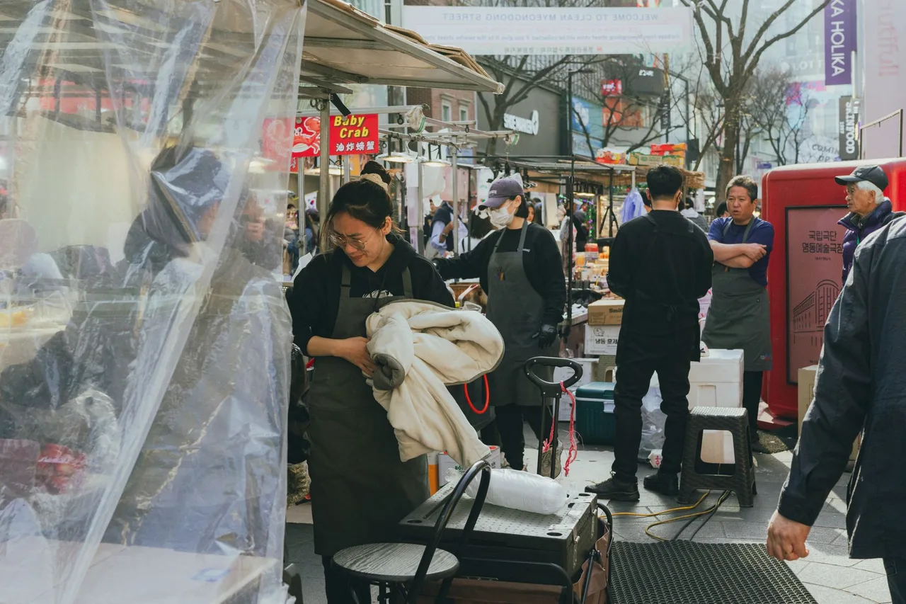 Shoppers along a busy Myeongdong street in Seoul