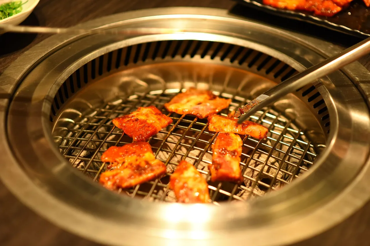 Samgyeopsal pork belly grilling on a Korean tabletop grill