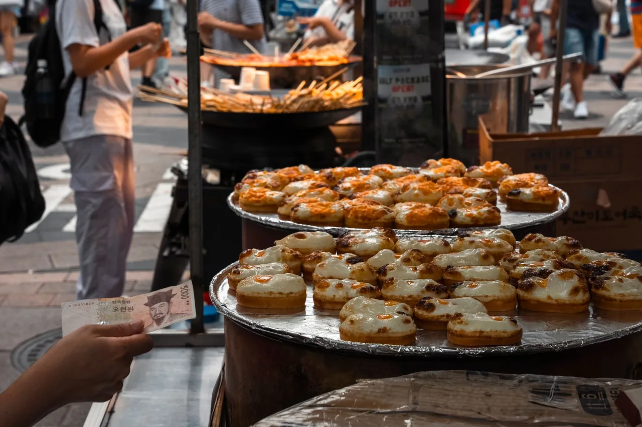 Vendors ladling broth at a Gwangjang market food alley