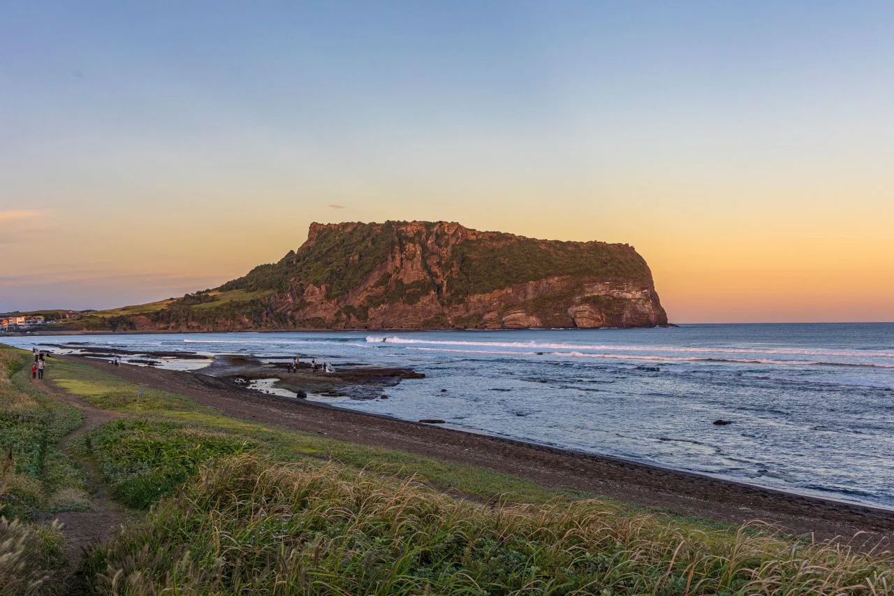 Seongsan Ilchulbong sunrise peak rising from the sea on Jeju