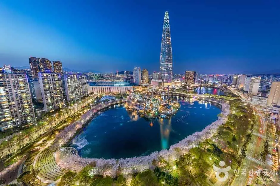 Seokchon Lake cherry blossoms with Lotte World Tower behind